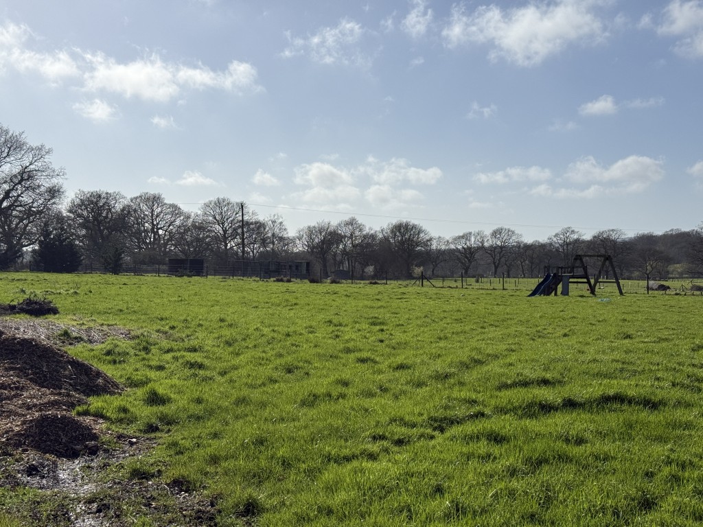 Lot: 83 - DEVELOPMENT SITE WITH OUTLINE PLANNING FOR THREE DETACHED SELF-BUILD DWELLINGS - Land with grass and fenced boundary
